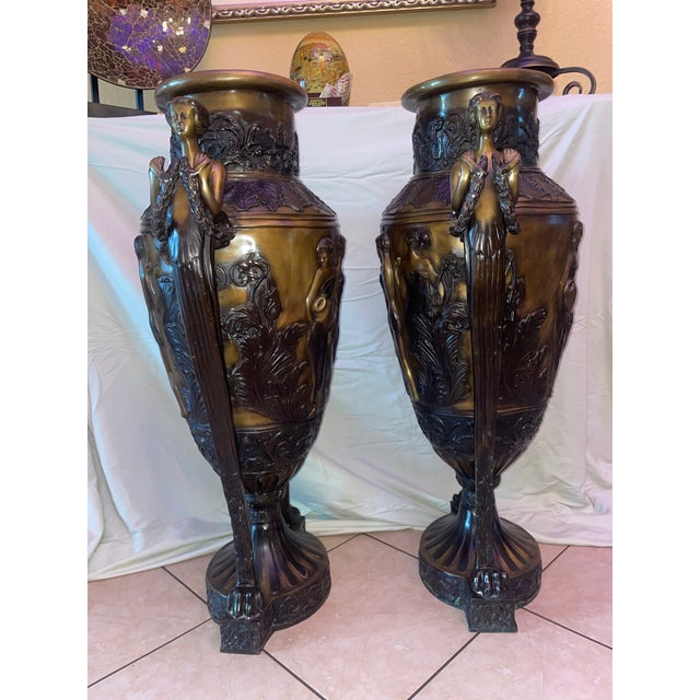 A pair of 19th century French URns, inspired by Greco ROman amphorae, decorated with mythological-style figures and...
