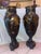 A pair of 19th century French URns, inspired by Greco ROman amphorae, decorated with mythological-style figures and...