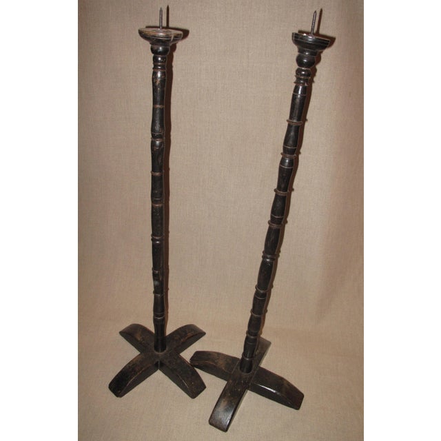 Offering a pair of ebonized turned oak pricket sticks, English circa 1870.