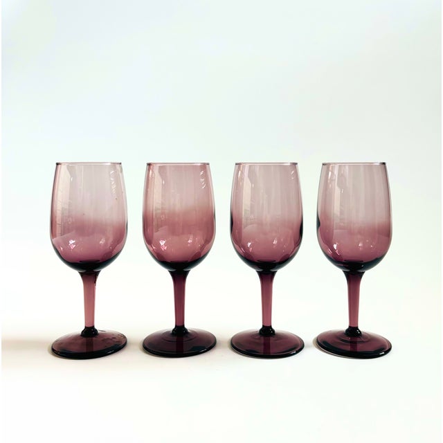 A gorgeous set of 4 vintage wine glasses in a dark purple hue. Each glass measures 2.25" in diameter x 6" tall.