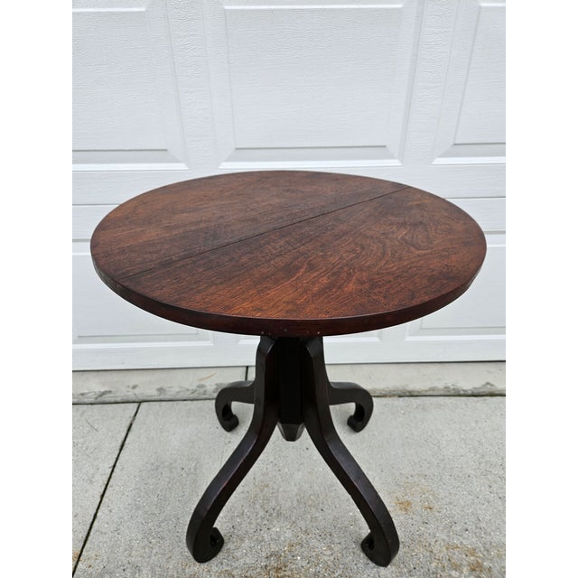 This antique primitive pedestal table features a thick hexagon cut pedestal supported by four curved legs. The thick...