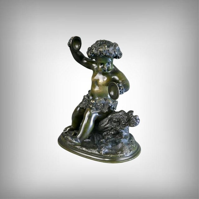 This bronze with a green patina of the young Bacchus, modeled with Clodion's characteristic sensual virtuosity, appears...