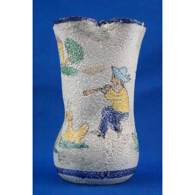 A stunning majolica earthenware vase, entirely hand-crafted on a lathe, finished with acid-treated glaze and decorated in...