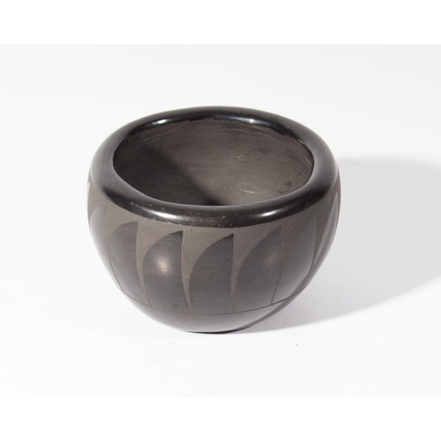 A blackware pottery vessel by Native American potter Ursulita Naranjo of the Santa Clara Pueblo in New Mexico. The vessel...