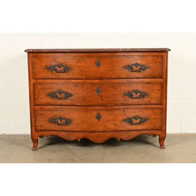 A gorgeous French Provincial Louis XV style commode or dresser chest By Ralph Lauren Circa Late 20th Century Solid carved...