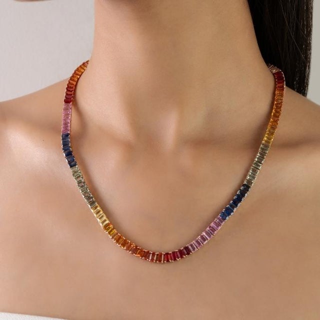 This elegant tennis necklace features octagon-cut natural rainbow sapphires totaling approximately 37.66 carats,...