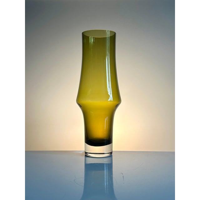 An elegant, sculptural glass vase, design number 1377, crafted in olive-green glass by the renowned Riihimäen Lasi Oy...