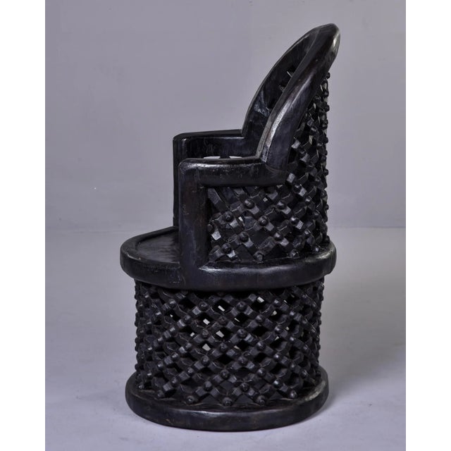 This circa 1980s hand carved African chair was made by a member of the Bamileke tribe from Cameroon. Hand carved dark...