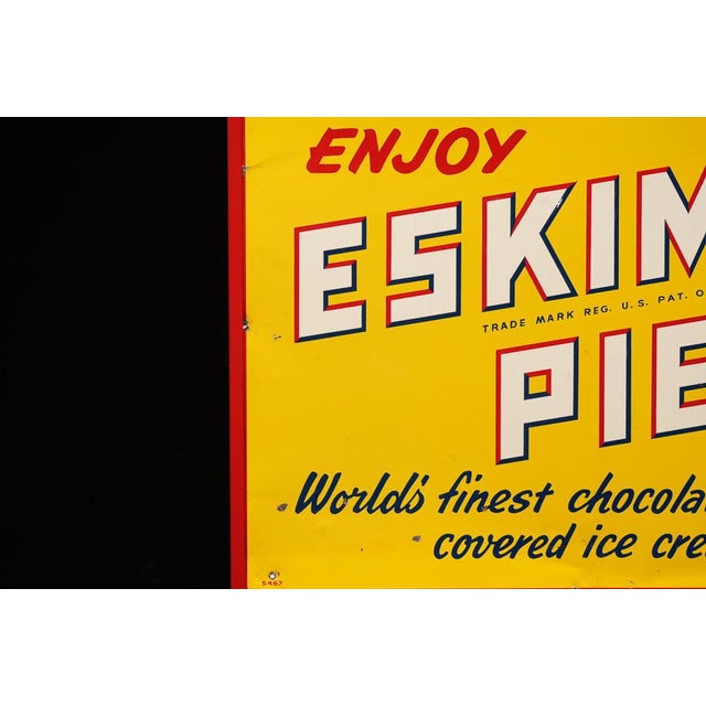 c. 1940s/1950s; Eskimo Pie Corporation - Richmond, VA A bold tin advertising sign for Eskimo Pie ice cream bars. The...