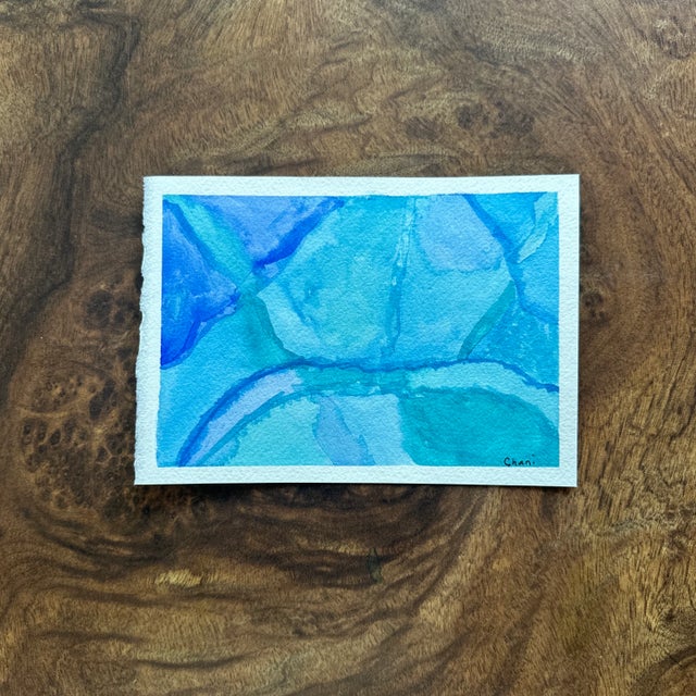 An abstract watercolor study in cool blues and teals, this piece evokes the quiet flow of water across stone or an aerial...