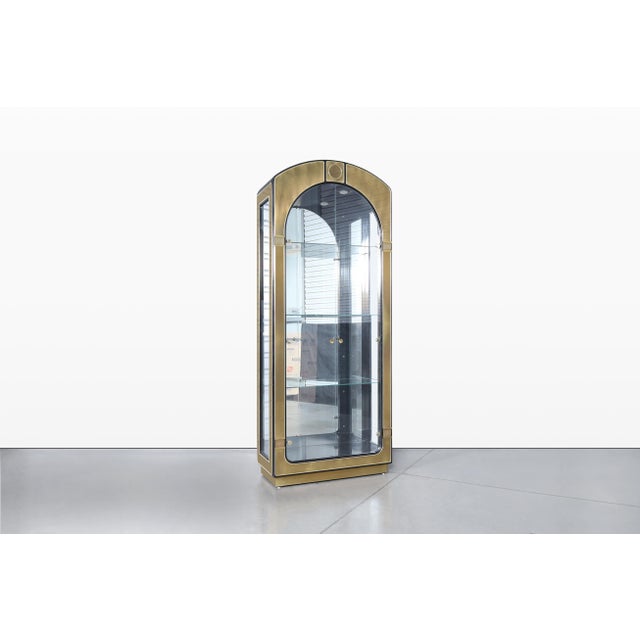 Discover the allure of refined vintage design with this exceptional Mastercraft brass vitrine display cabinet....