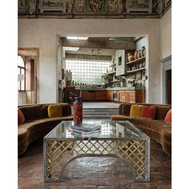 A commanding and structurally striking example of 1970s Hollywood Regency design, this oversized square cocktail table...