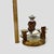 This is a charming vintage Sitzendorf porcelain spill vase featuring a young boy in 18th-century attire perched atop a...