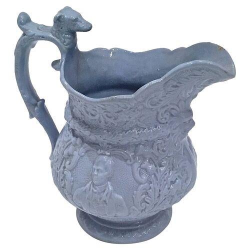 Antique bas-relief pitcher featuring a gentleman's portrait on each side with acanthus patterned detailing. A greenman...