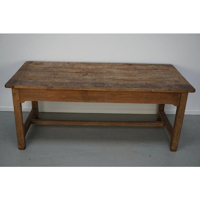 This elegant table was made in France in the 18th century. The table was made in solid elm with beautiful grain patterns....