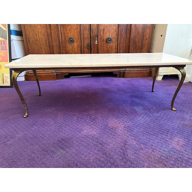 Vintage French neoclassical style marble-top coffee or cocktail table with a brass base. The marble slab can be removed or...