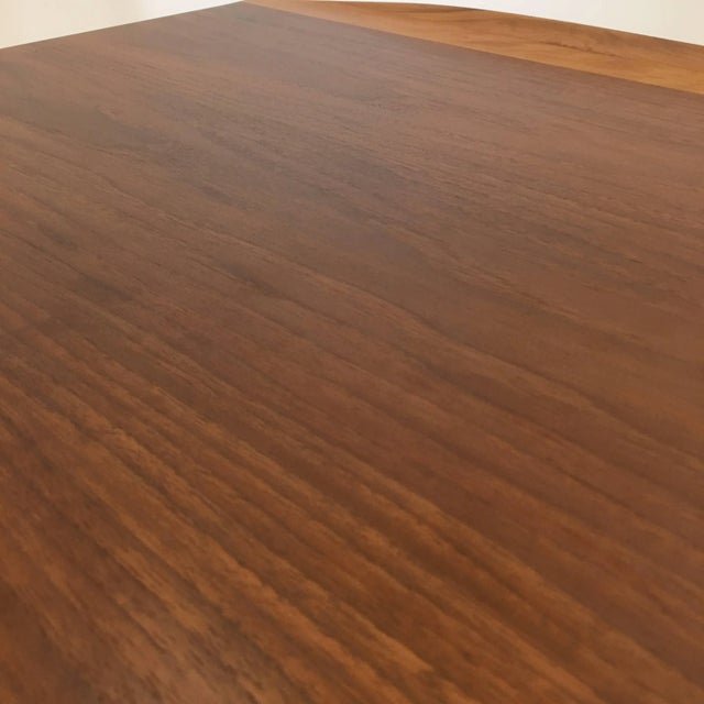 Solid surfboard stylized edges and magazine rack shelf. Features raised edges typical of Danish modern production, but...