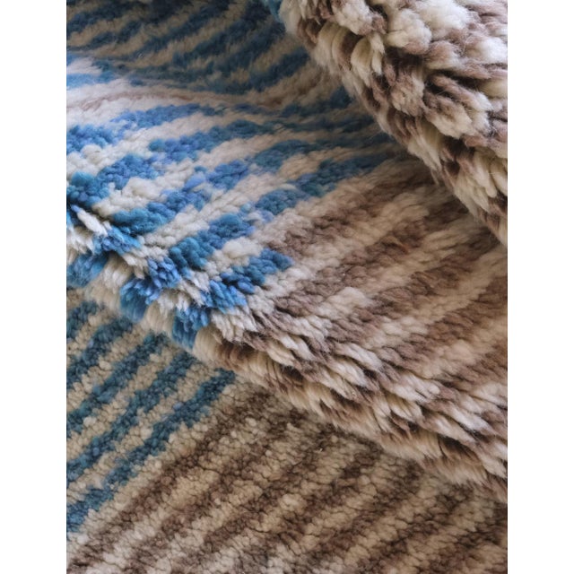 This Moroccan Beni MRirt wool rug measures 10.1 x 7 ft and features a stunning geometric design. Expertly handcrafted for...