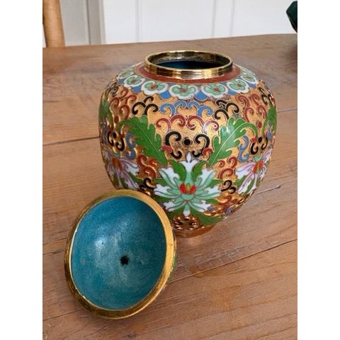 A beautifully detailed vintage Chinese cloisonné ginger jar, hand-enameled over a rich gold ground with a dense pattern of...