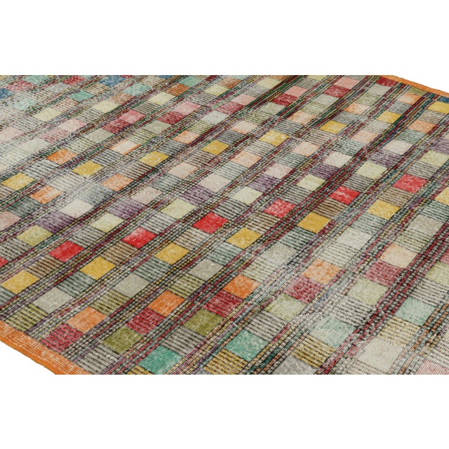 Hand-knotted in wool circa 1960-1970, this 6x10 vintage rug is an exciting new piece in Rug & Kilim’s Mid-Century Pasha...