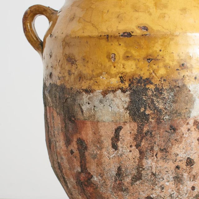 Antique French Confit Pot Jar A nineteenth century French confit pot jar with classic dark yellow pottery and glaze....