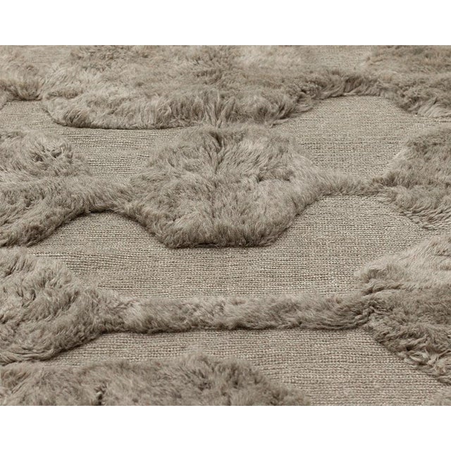 This hand-knotted wool rug in Desert Taupe features a refined organic pattern composed of softly raised abstract shapes,...