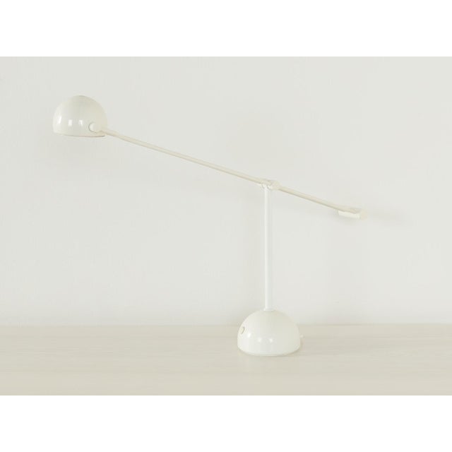 Wonderful desk lamp from the 1970s by Hustadt Leuchten. Swiveling telescopic arm with a lampshade and base made of white...