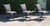A set of three Restoration Hardware swivel desk chairs featuring sculptural, gently curved seats upholstered in charcoal...