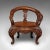 This is a vintage decorative elbow chair, an Oriental, relief carved mahogany fireside or hall seat, dating to the late...