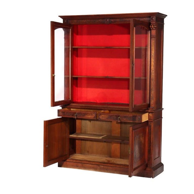 An antique step-back bookcase crafted from walnut and decorative burl wood, dating to circa 1880. This piece of Victorian...
