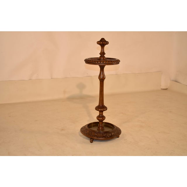 19th century hand carved oak umbrella stand from England. The top is decorated with a hand turned and carved finial,...