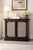 A sophisticated Hollywood Regency flip-top bar cabinet dating to the 1970s, executed in an ebonized finish with classical...