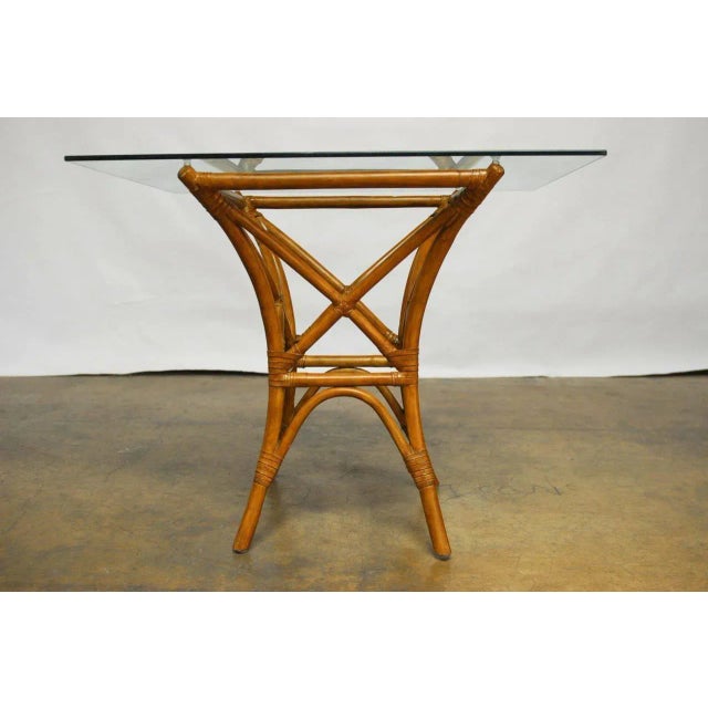 A sleek and modern dining table with a tapered geometric form and flared legs from the 1980s. Features architectural...