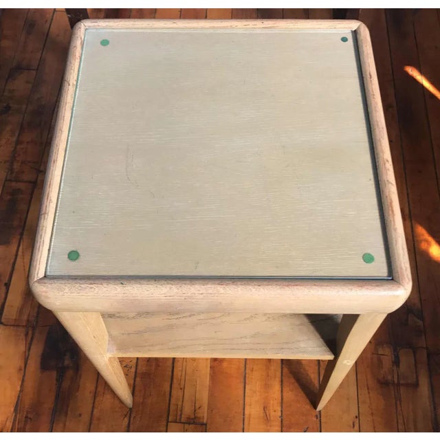 Mod century modern two tiered wooden side table with rounded corners. Blond pickled wood with glass insert on the top....