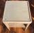 Mod century modern two tiered wooden side table with rounded corners. Blond pickled wood with glass insert on the top....