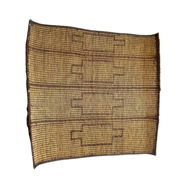Handwoven Tuareg rug, originating from Mauritania. Made from natural plant fibers and structured with leather strips, this...