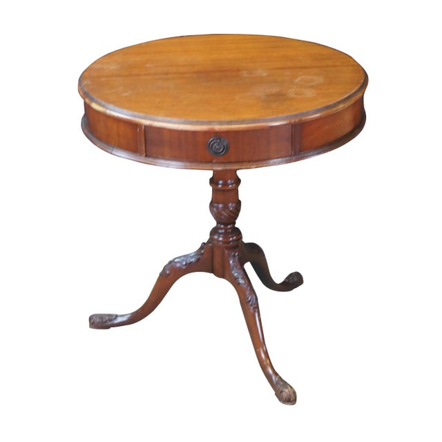 An antique Georgian style drum table. Made from mahogany with rounded top featuring a drawer within the frieze over a...