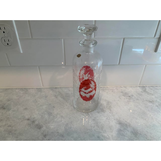 Beautiful bohemian art glass bottle/decanter. One side features a stag, the other a pheasant. Gorgeous etching.