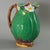 Minton Majolica jug/pitcher which features flowering lilies and lily pads. Colouration: green, dark pink, white, are...