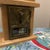 This vintage-style piece is a Post Office Box Door Bank, a popular collectible that repurposes authentic antique postal...