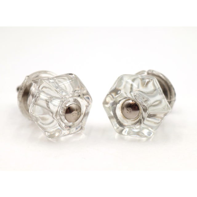 Antique cabinet or drawer knobs made of clear glass with chrome finished steel screws. Good condition with surface wear...