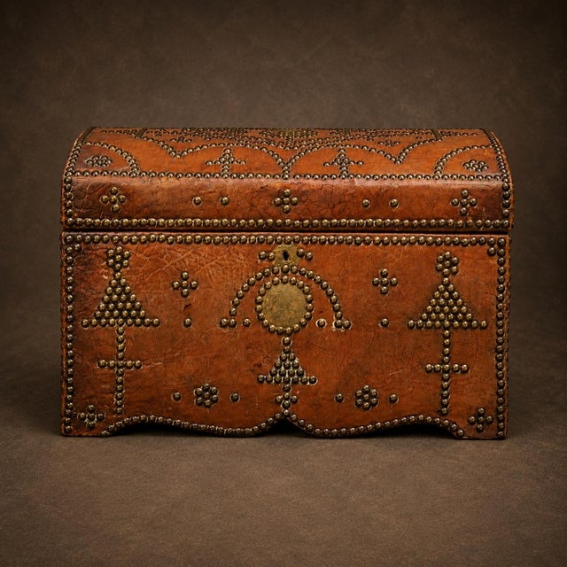 This 19th Century English Leather Storage Box is a richly detailed antique piece wrapped in beautifully aged leather with...