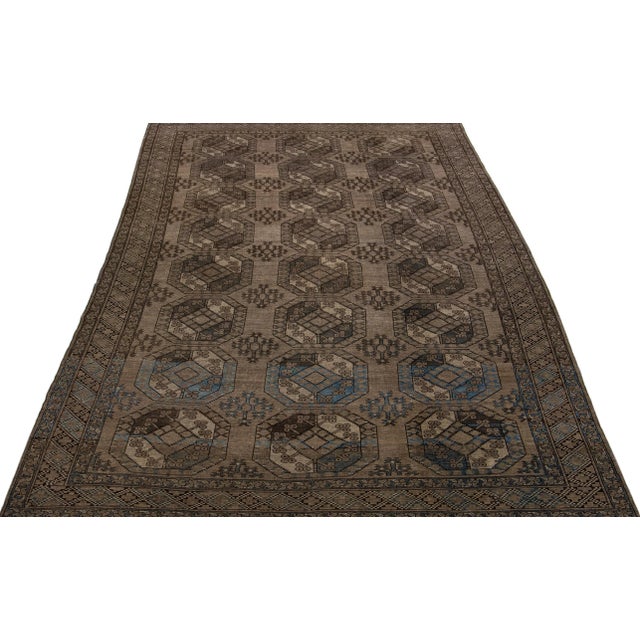 Beautiful antique Turkmen hand-knotted wool rug with a brown color field in a gorgeous all-over Gul pattern design. This...