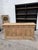 This antique sideboard made of solid elm has been fully restored. It features 3 large, functional drawers and 3 solid...