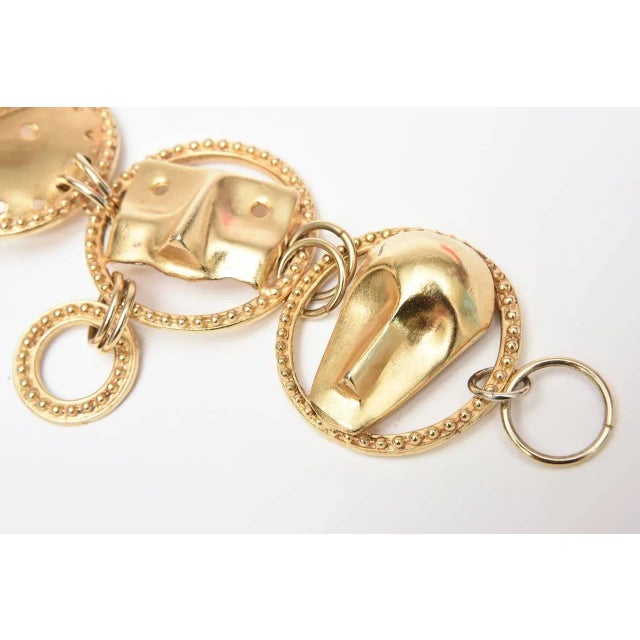 This is part of Chairish’s Costume Jewelry assortment. This unusual link Japanese gold plated bracelet has 4 abstract face...