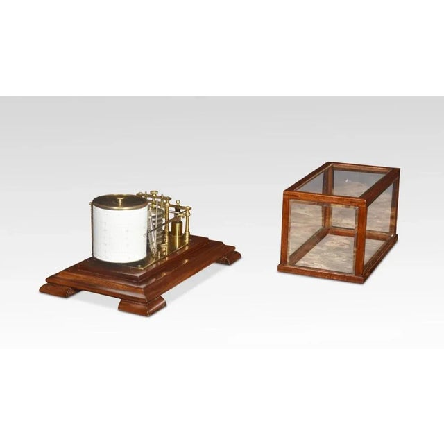 Walnut Cased Barograph, having five glazed removable lid. The mechanical eight-day movement is housed in the drum, fitted...