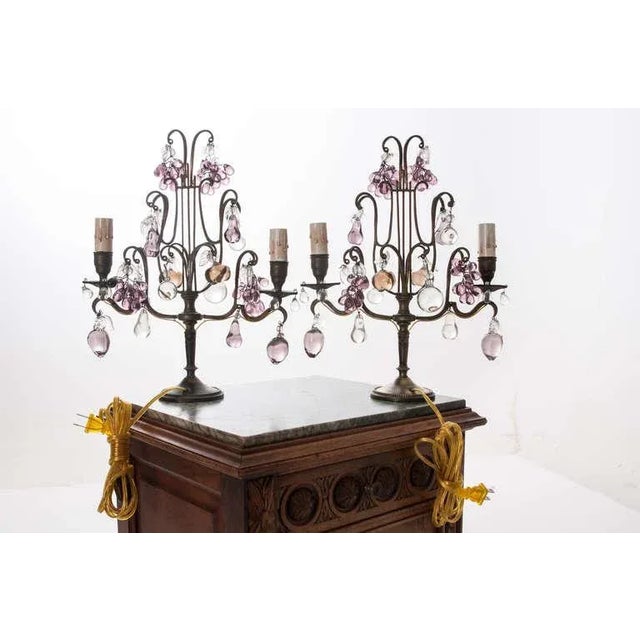 An adorable pair of French candelabra, adorned with clusters of glass fruit and droplets mixing clear and amethyst-toned...