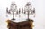 An adorable pair of French candelabra, adorned with clusters of glass fruit and droplets mixing clear and amethyst-toned...