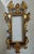 A vintage Italian Hollywood Regency Mirror or Picture Frame. The frame is carved wood with a gilt gold finish.