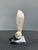 A sculptural abstract figure carved from richly banded cream onyx and mounted to a contrasting stone base. Defined by...